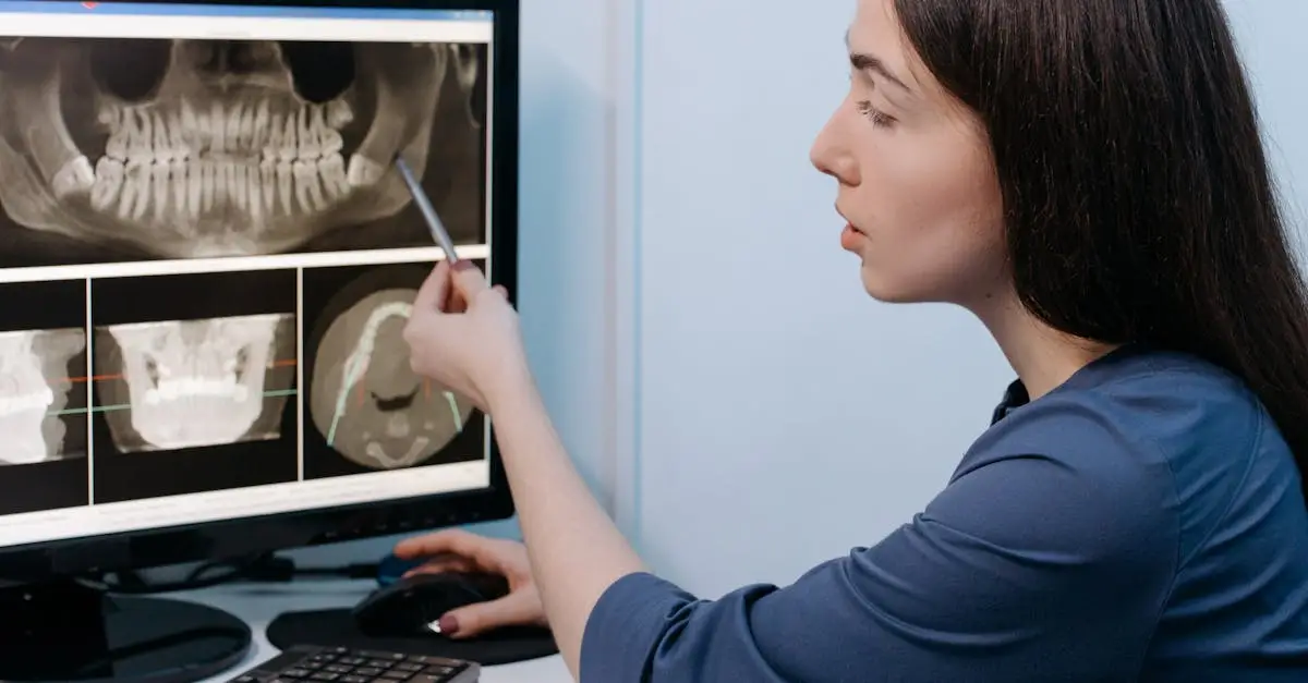 Female dentist examining dental X-ray images on computer screen in clinic.